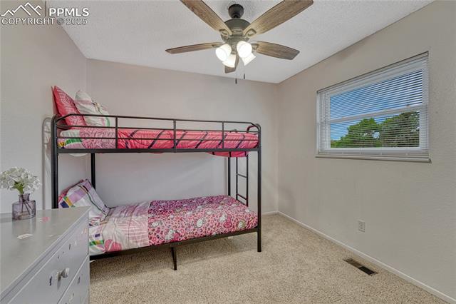 7108 Chippewa Road Colorado Springs, CO 80915 - Photo 18 of 40 Secondary bedroom on upper level with fresh paint, new blinds, and ceiling fan