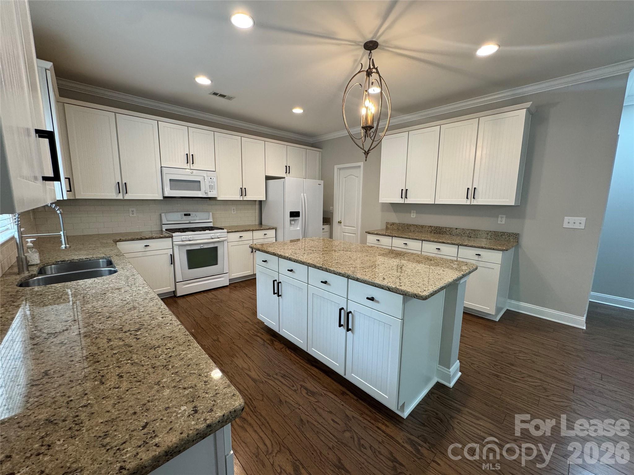 10921 Rousay Road Charlotte, NC 28278 - Photo 2 of 17 a kitchen with stainless steel appliances granite countertop a stove a sink and a refrigerator