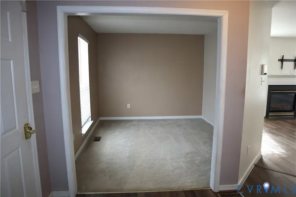 a view of empty room with a fireplace