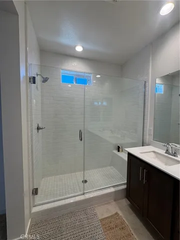 a bathroom with a shower and a sink