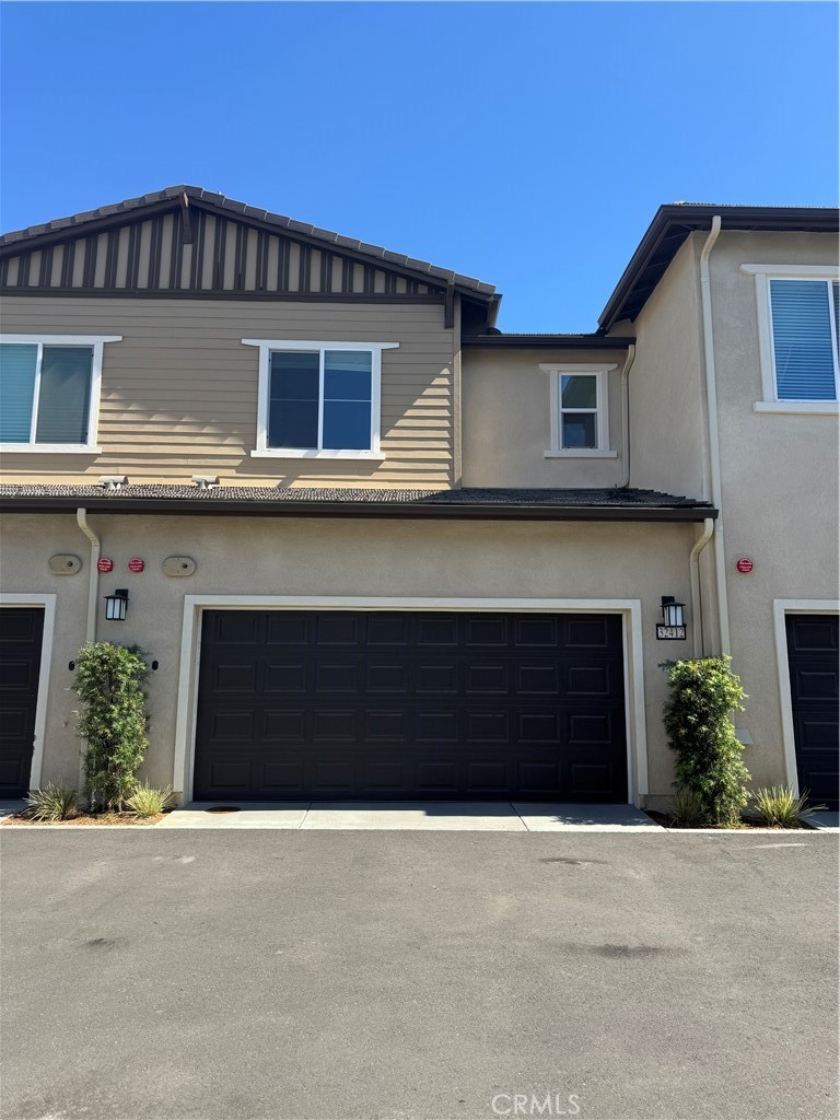 32412 Tannat Drive Temecula, CA 92591 - Photo 27 of 28 a front view of a house with a yard and garage