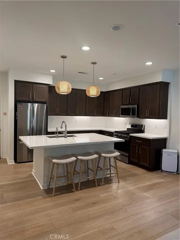 a large kitchen with a table and chairs