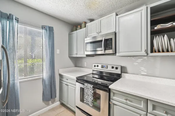 a kitchen with stainless steel appliances a stove a microwave and cabinets
