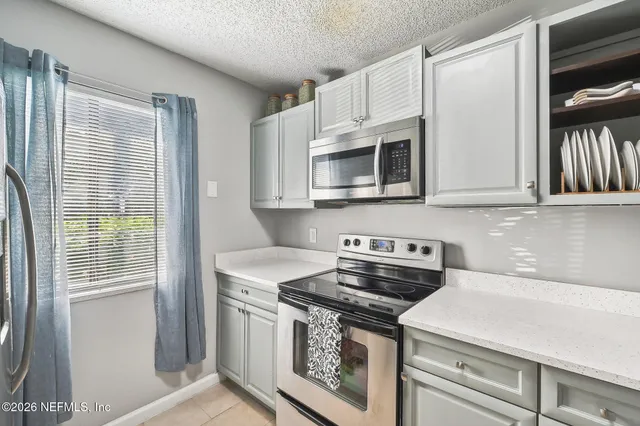 a kitchen with stainless steel appliances a stove a microwave and cabinets