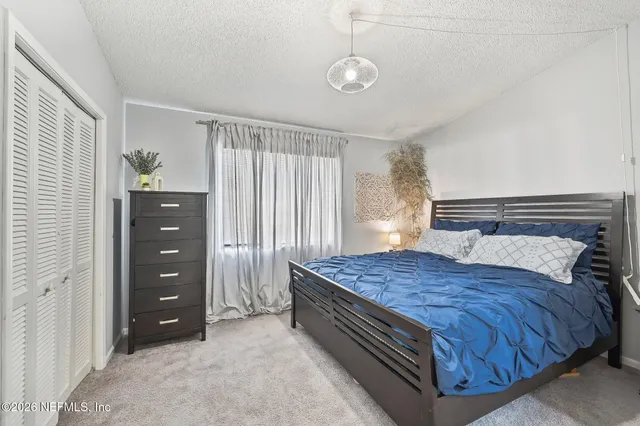 a bedroom with a bed and a dresser