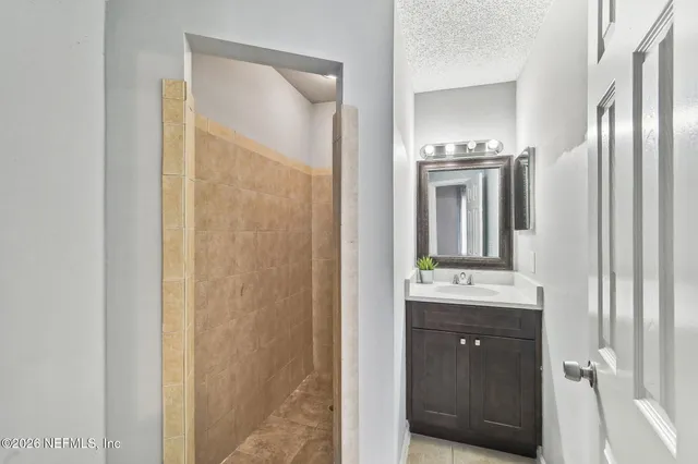 a bathroom with a double vanity sink and mirror