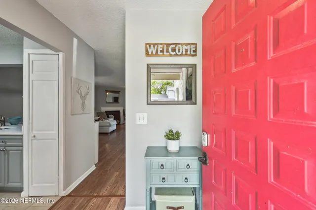 a view of an entryway with wooden floor