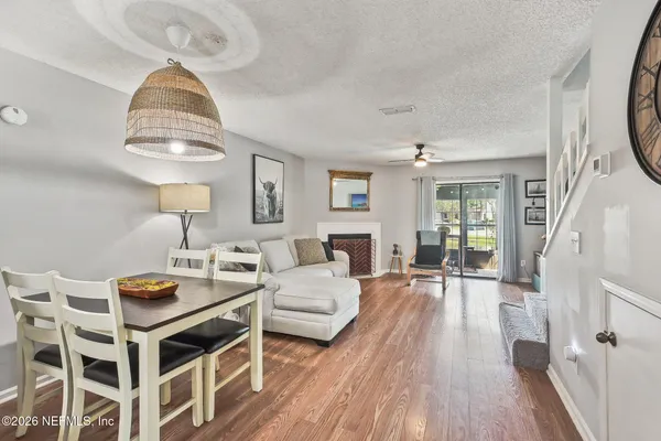 a living room with furniture a fireplace and a table