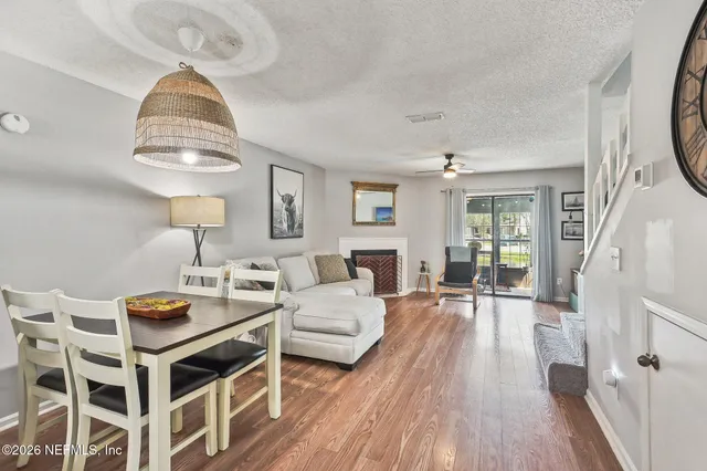 a living room with furniture a fireplace and a table