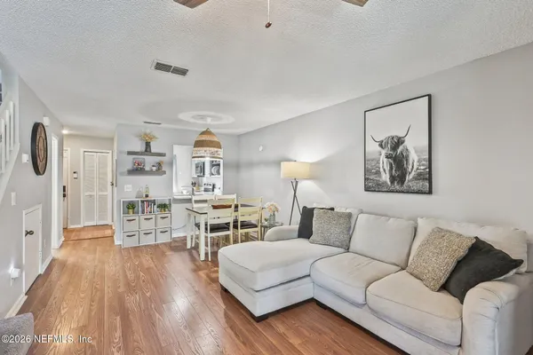 a living room with furniture and a wooden floor
