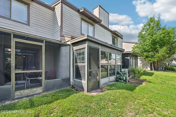 a view of a house with yard and a garden