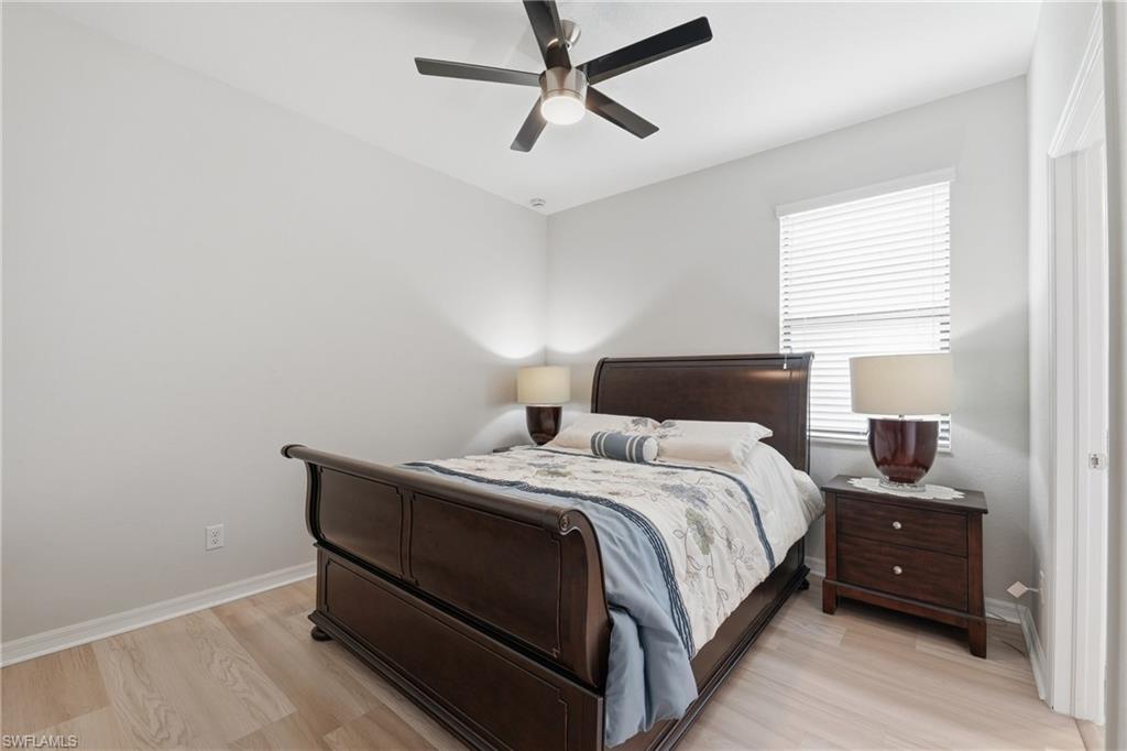 4374 Bismark Way Naples, FL 34119 - Photo 20 of 49 Room featuring light wood-finish flooring, a ceiling fan with integrated lighting, and a window with horizontal blinds