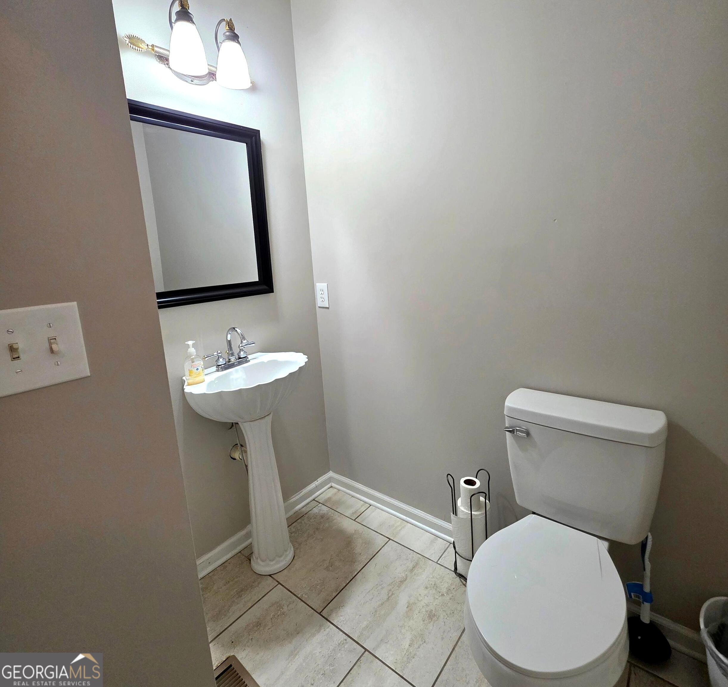 3117 Fairmond Court Villa Rica, GA 30180 - Photo 12 of 20 a bathroom with a toilet sink and mirror