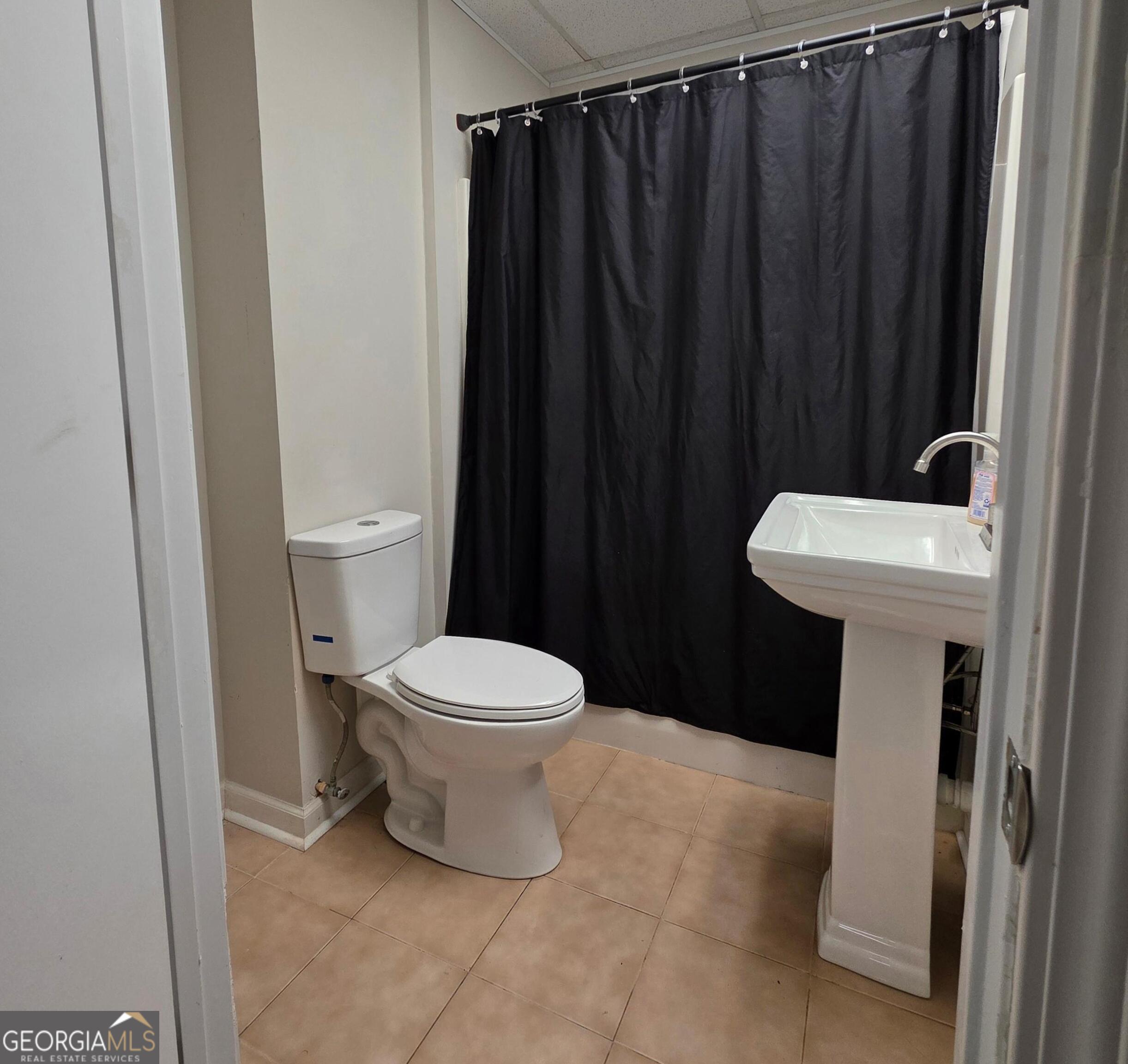 3117 Fairmond Court Villa Rica, GA 30180 - Photo 19 of 20 a bathroom with a sink a toilet and a shower