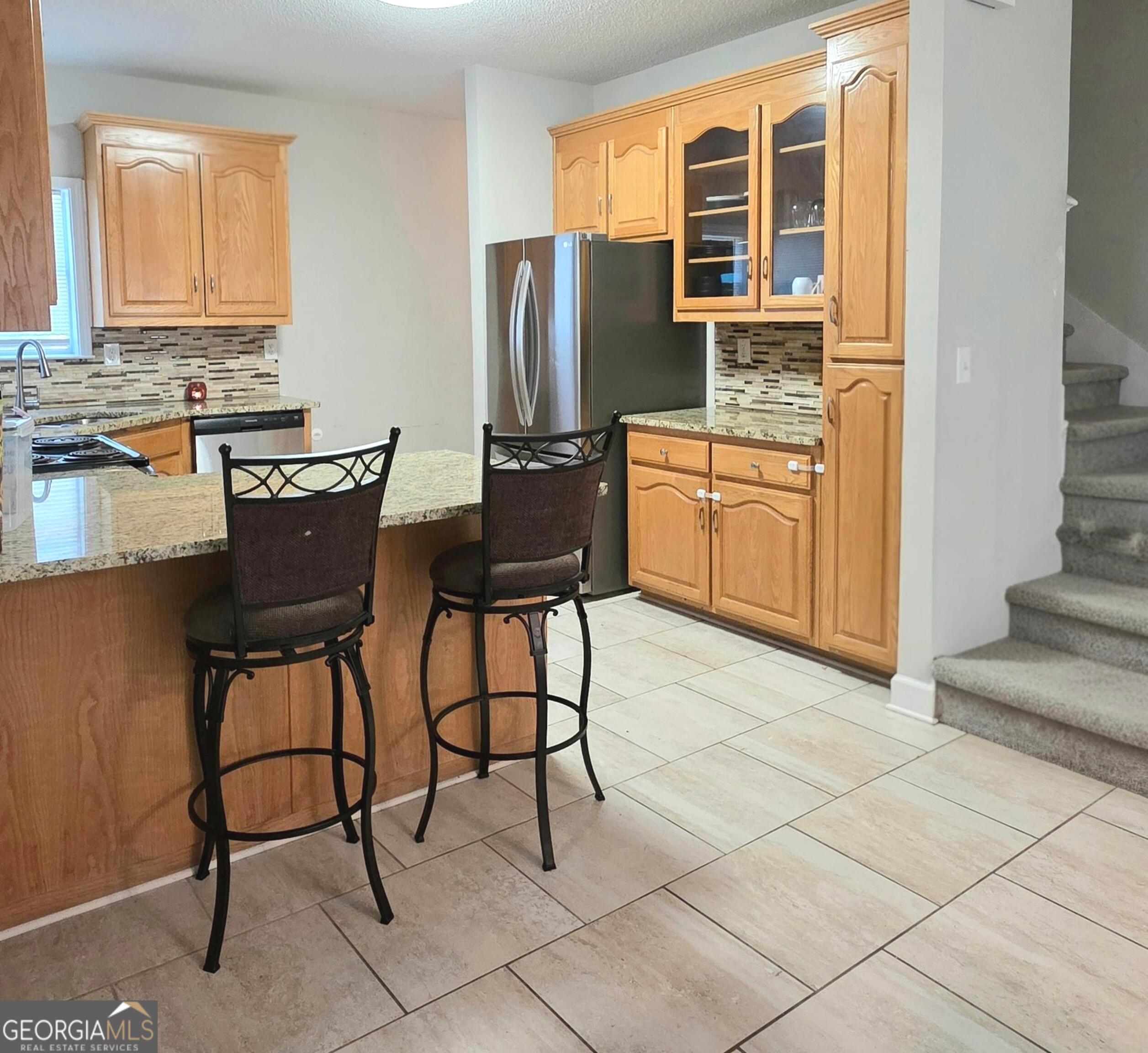 3117 Fairmond Court Villa Rica, GA 30180 - Photo 7 of 20 a view of kitchen with stainless steel appliances granite countertop a stove a refrigerator and a dining table next to a window