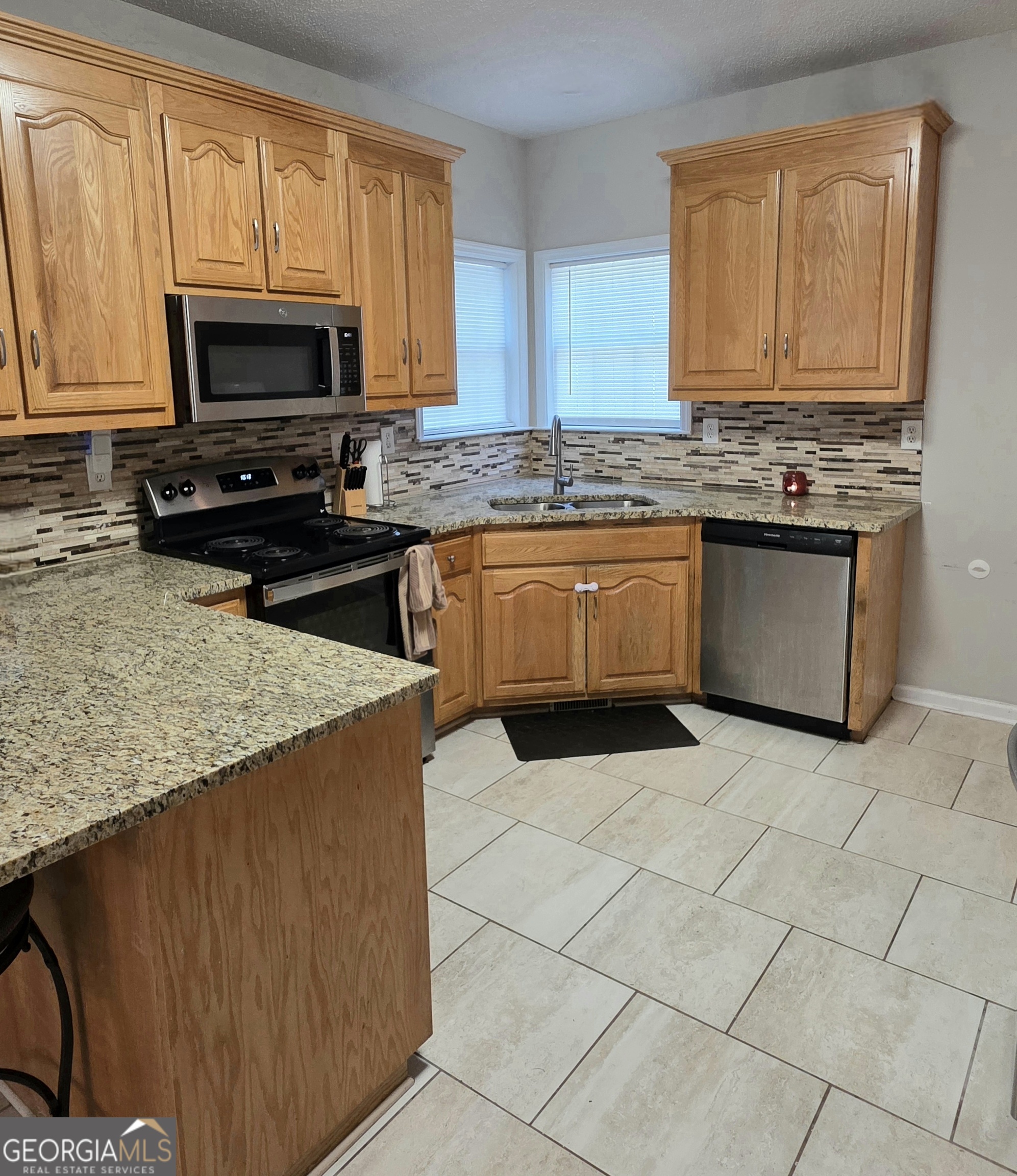 3117 Fairmond Court Villa Rica, GA 30180 - Photo 8 of 20 a kitchen with stainless steel appliances granite countertop a stove a sink and a microwave