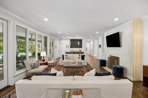 a living room with fireplace furniture and a flat screen tv