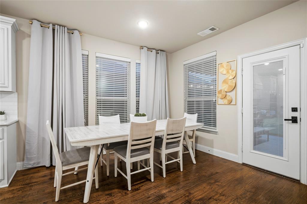 1802 Roundtree Road Forney, TX 75126 - Photo 17 of 39 a dining room with furniture and wooden floor