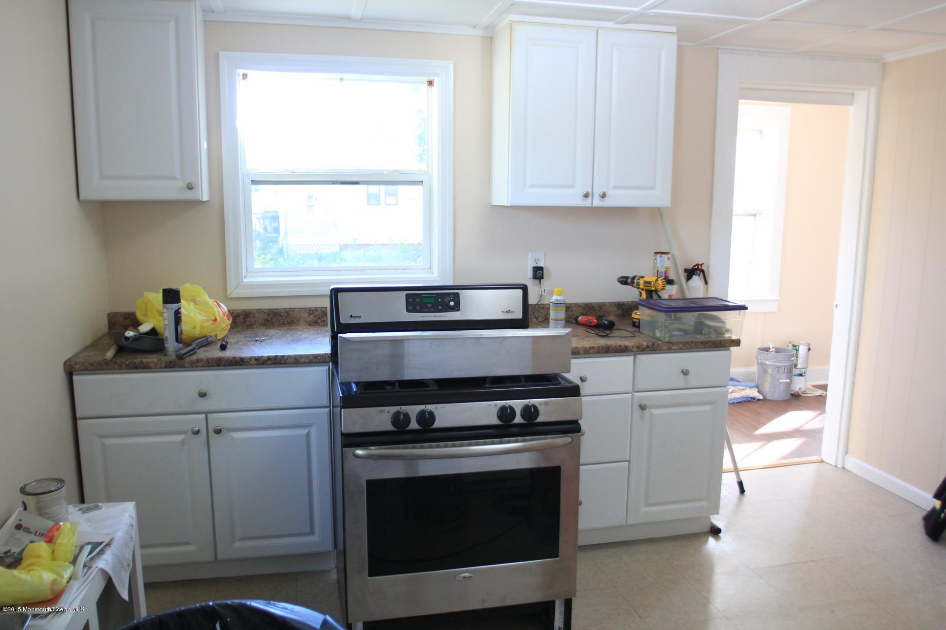 121 Branchport Avenue, Unit A Long Branch, NJ 07740 - Photo 11 of 21 a kitchen with a stove a sink and a window
