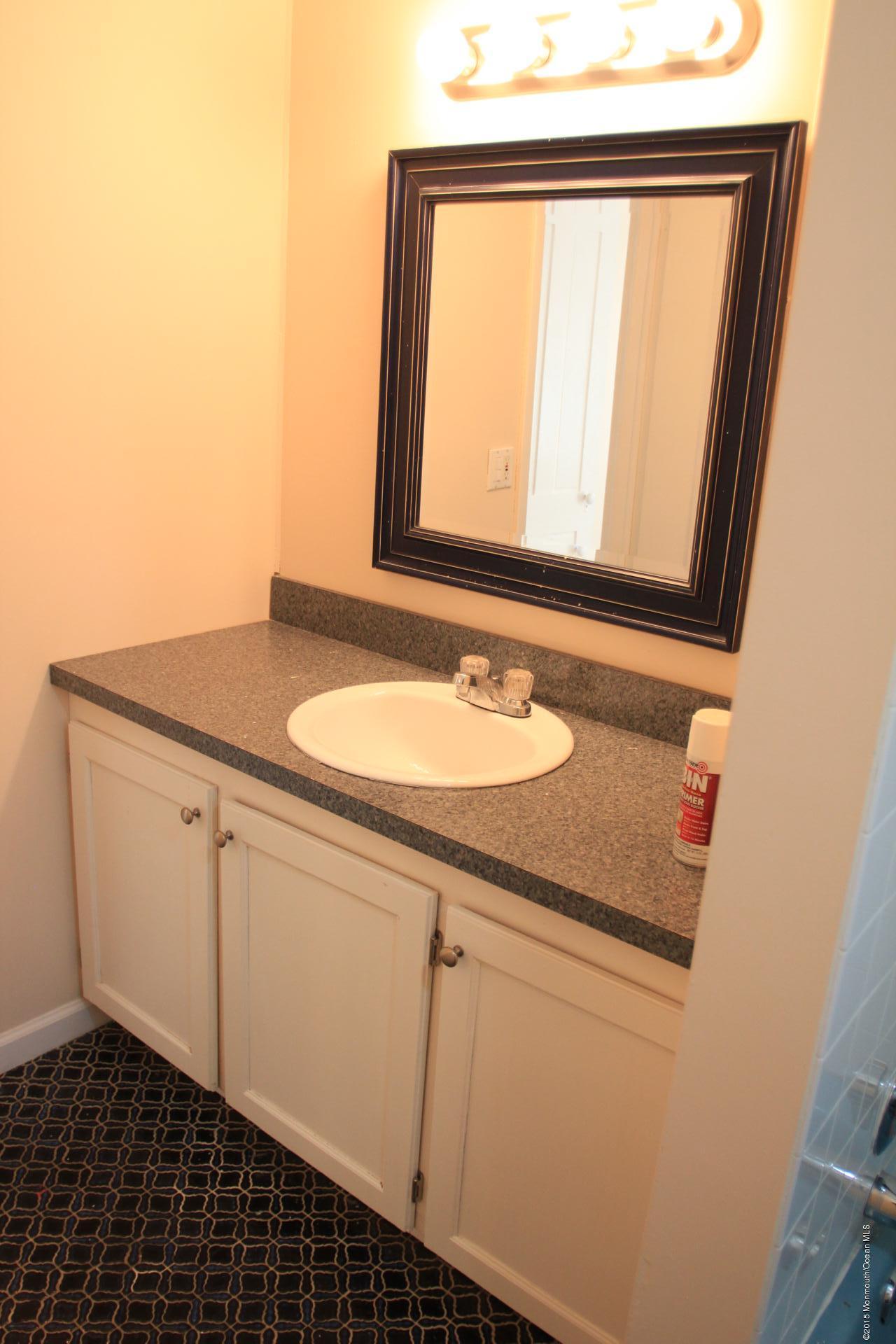 121 Branchport Avenue, Unit A Long Branch, NJ 07740 - Photo 18 of 21 a bathroom with a sink and a mirror