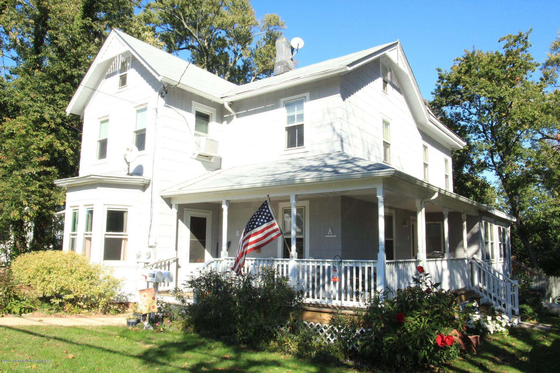 121 Branchport Avenue, Unit A Long Branch, NJ 07740 - Photo 4 of 21 a view of small white house with a small yard and potted plants