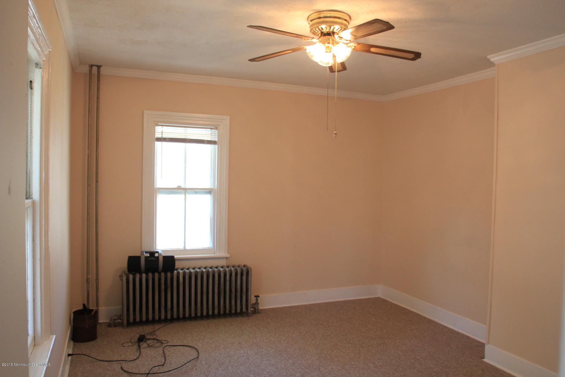 121 Branchport Avenue, Unit A Long Branch, NJ 07740 - Photo 6 of 21 an empty room with windows and ceiling fan