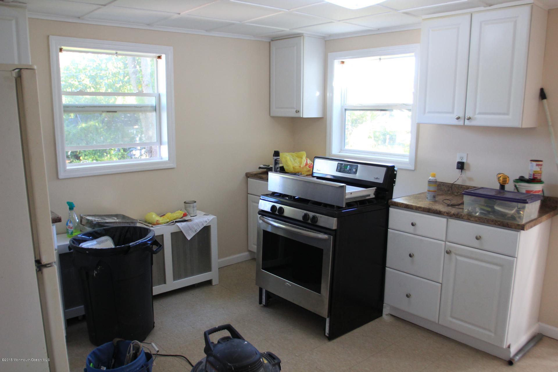 121 Branchport Avenue, Unit A Long Branch, NJ 07740 - Photo 10 of 21 a kitchen with stainless steel appliances granite countertop a stove a sink dishwasher and cabinets with wooden floor
