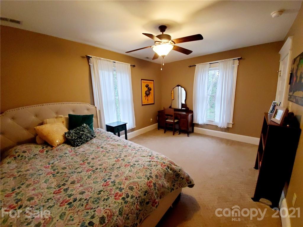 314 Mitchell Avenue Salisbury, NC 28144 - Photo 14 of 19 a bedroom with a bed and dresser with mirror