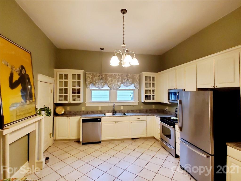 314 Mitchell Avenue Salisbury, NC 28144 - Photo 6 of 19 a kitchen with stainless steel appliances granite countertop a stove a sink and a refrigerator