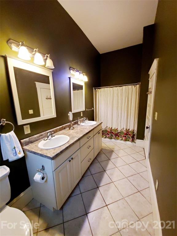314 Mitchell Avenue Salisbury, NC 28144 - Photo 10 of 19 a bathroom with a sink a toilet and mirror