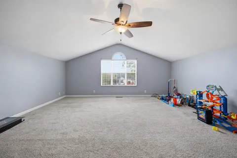 a view of a room with toys and a chandelier