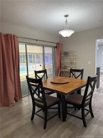 a view of a dining room with furniture and window
