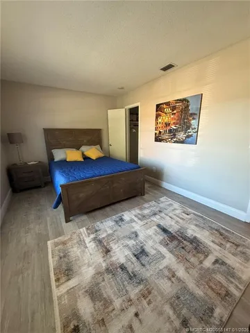 a bedroom with a bed and a couch