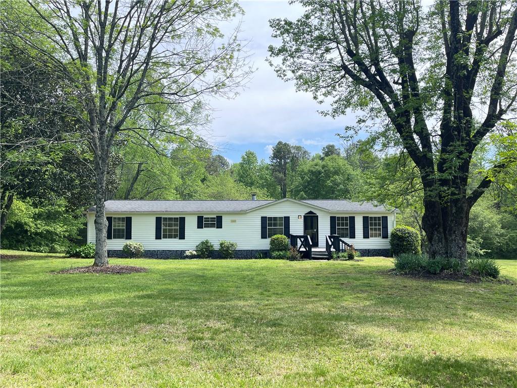 5219 Bogus Road Gainesville, GA 30506 - Photo 1 of 1 a front view of a house with a yard table and chairs