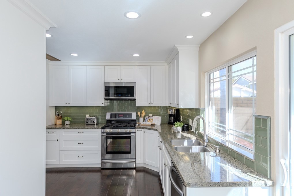 19542 Drybrook Lane Huntington Beach, CA 92646 - Photo 15 of 55 Kitchen has Recessed Lighting and Windows with a View to the Backyard