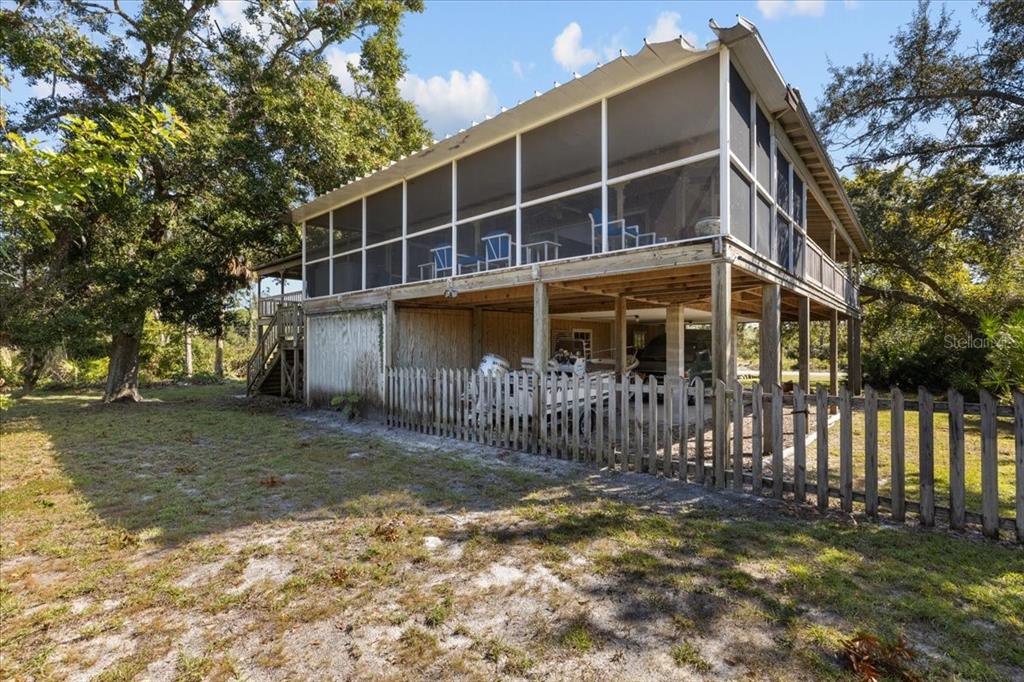 16791 Sandra Street Cedar Key, FL 32625 - Photo 13 of 50 a view of a house with a yard