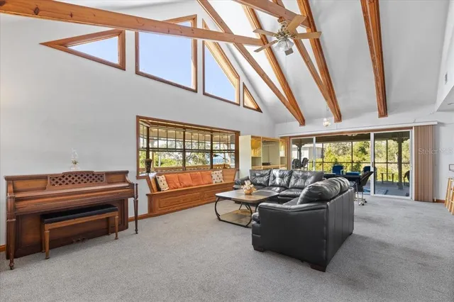 a living room with furniture and a floor to ceiling window