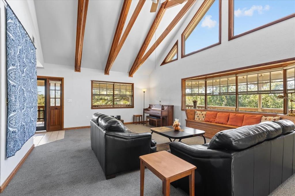 16791 Sandra Street Cedar Key, FL 32625 - Photo 15 of 50 a living room with furniture and a floor to ceiling window