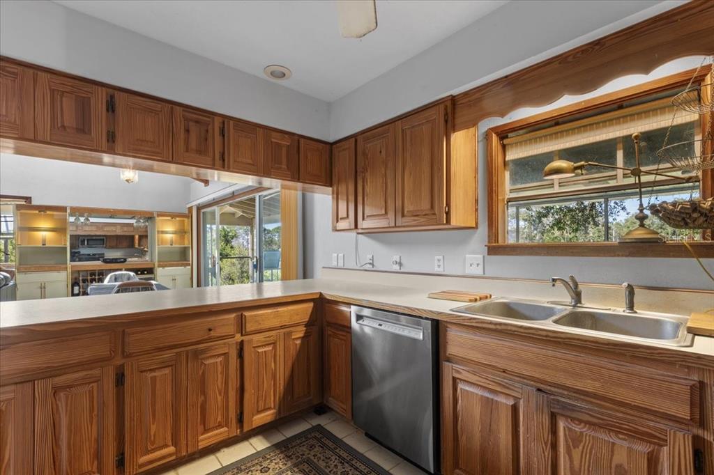 16791 Sandra Street Cedar Key, FL 32625 - Photo 19 of 50 a kitchen with sink cabinets and window