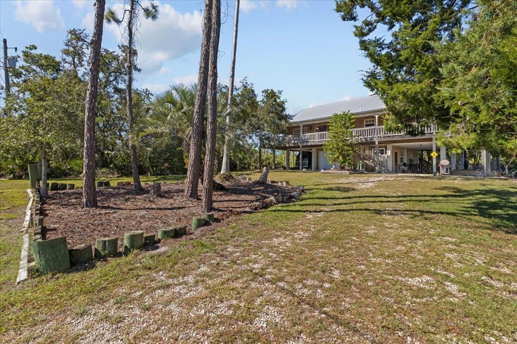 16791 Sandra Street Cedar Key, FL 32625 - Photo 2 of 50 a front view of a house with a yard