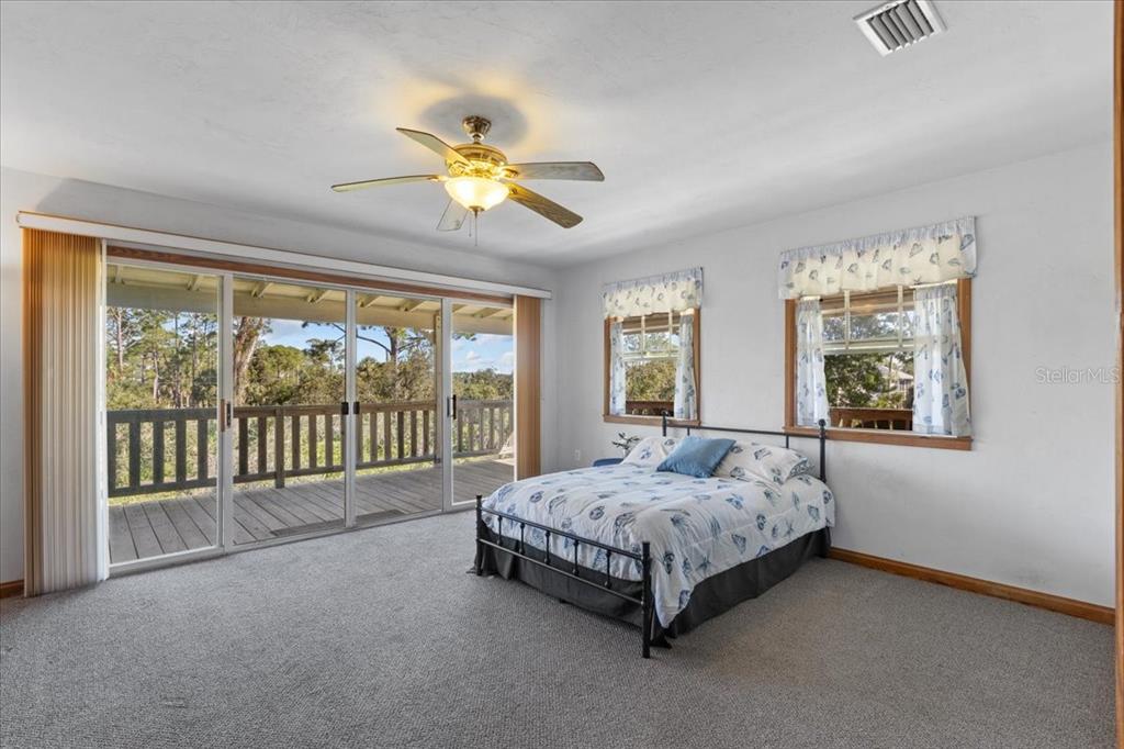 16791 Sandra Street Cedar Key, FL 32625 - Photo 24 of 50 a bed sitting in a bedroom next to a window