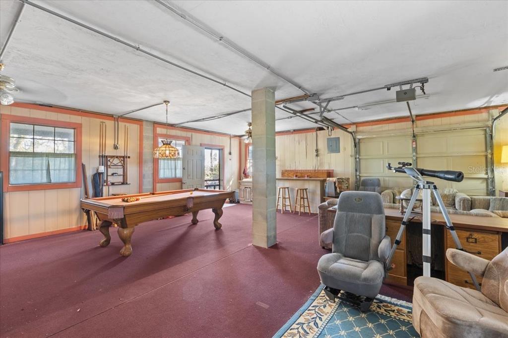 16791 Sandra Street Cedar Key, FL 32625 - Photo 24 of 50 a living room with furniture a rug and a floor to ceiling window