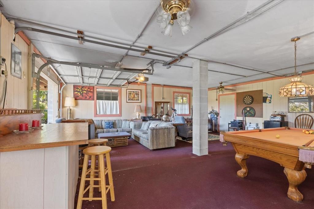 16791 Sandra Street Cedar Key, FL 32625 - Photo 25 of 50 a dining room with furniture and a chandelier