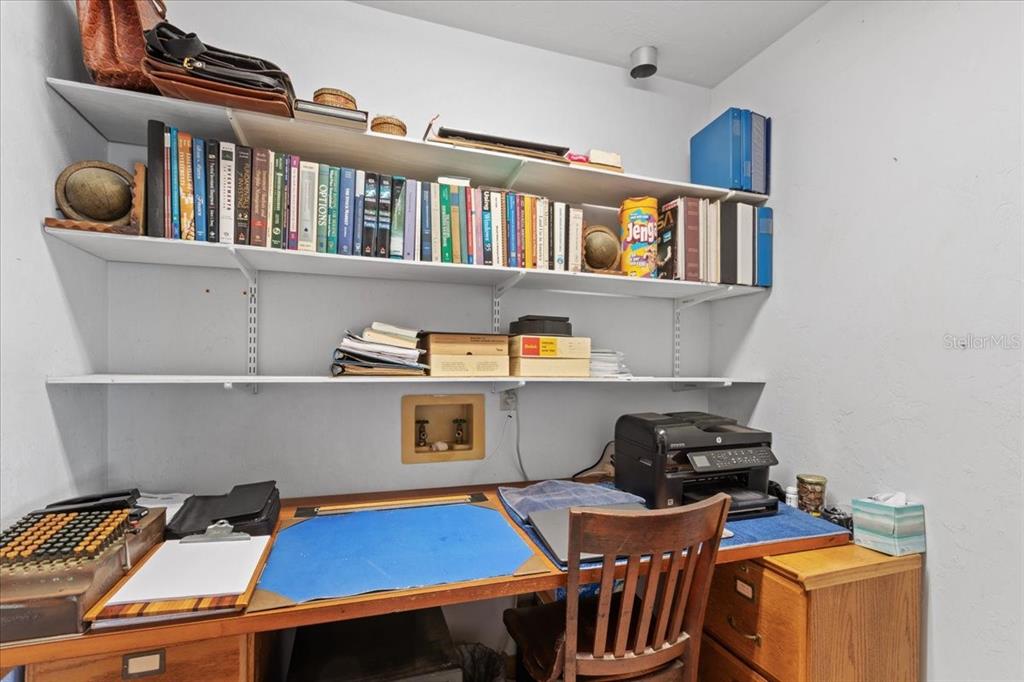 16791 Sandra Street Cedar Key, FL 32625 - Photo 26 of 50 a view of a workspace with furniture and book shelf