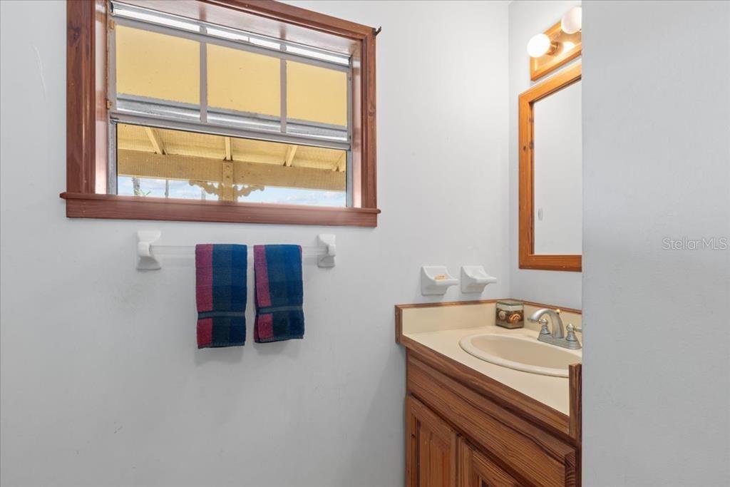 16791 Sandra Street Cedar Key, FL 32625 - Photo 28 of 50 a bathroom with a sink and a window