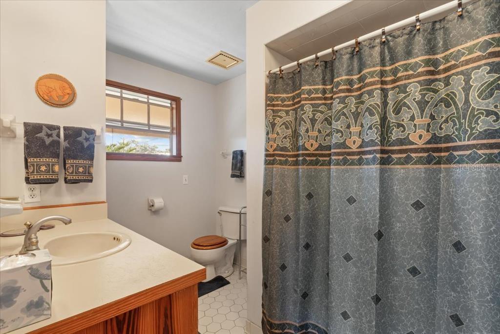 16791 Sandra Street Cedar Key, FL 32625 - Photo 29 of 50 a bathroom with a sink and a mirror