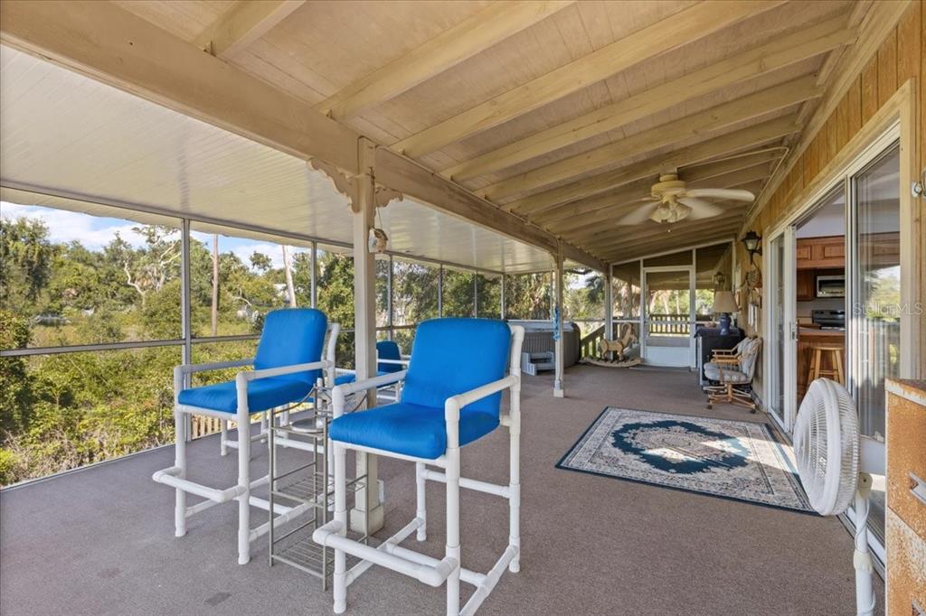 16791 Sandra Street Cedar Key, FL 32625 - Photo 35 of 50 a view of a chairs and table in patio with a barbeque