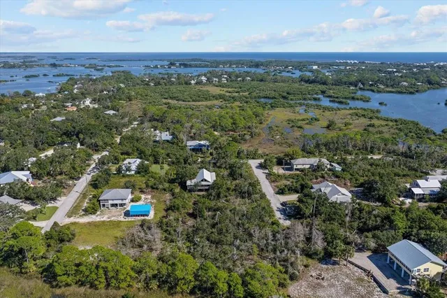 an aerial view of a houses with a yard