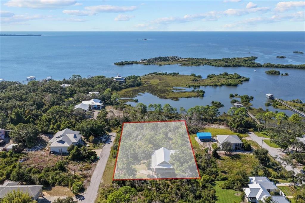 16791 Sandra Street Cedar Key, FL 32625 - Photo 46 of 50 an aerial view of a house with a lake view