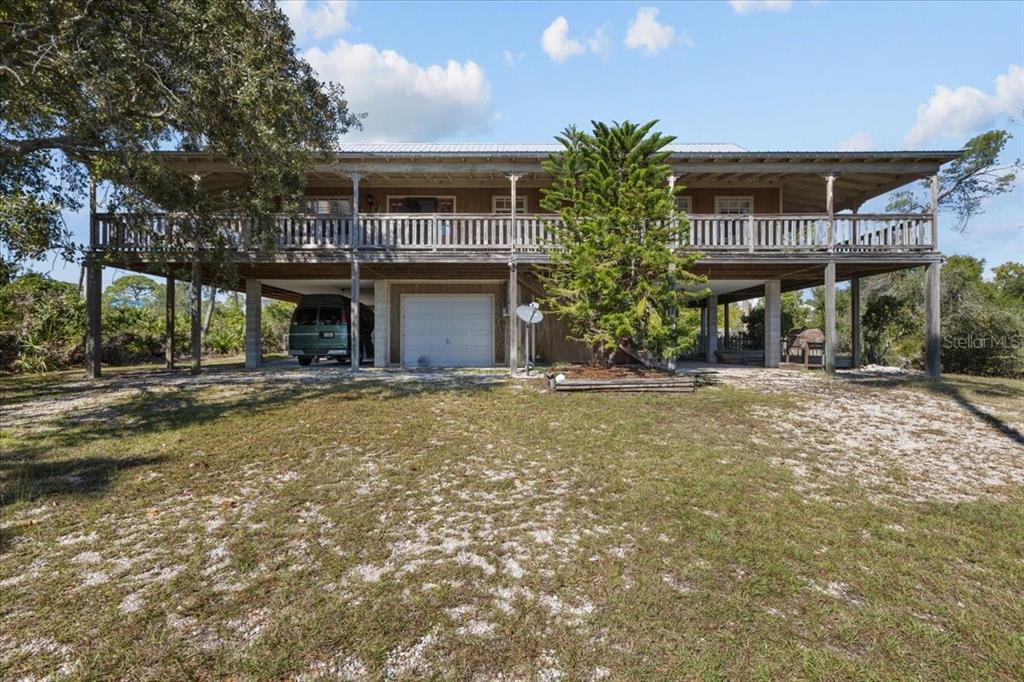 16791 Sandra Street Cedar Key, FL 32625 - Photo 5 of 50 a view of a house with a yard